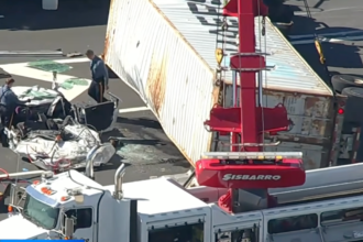 Truck overturns swerving to avoid traffic, fatally flattening car