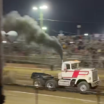 Semi truck crashes through barrier at truck pull event after pulling away from sled in spectator video