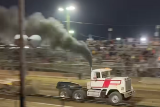 Semi truck crashes through barrier at truck pull event after pulling away from sled in spectator video