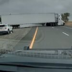 Semi truck ruptures own air line attempting u-turn through I-5 median 