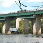 Crane gently lifts box truck out of river after seven vehicle crash sends it off bridge