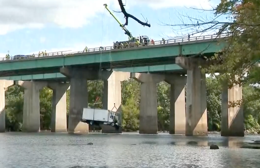Crane gently lifts box truck out of river after seven vehicle crash sends it off bridge