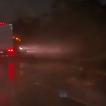 Semi truck sliding on rainy road misses smashing a four wheeler by just a hair: VIDEO