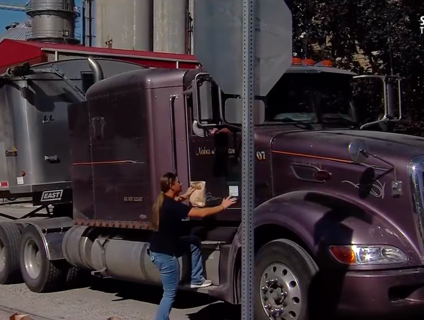 Midwestern truck drivers handed free lunches while waiting in line to drop off their harvests