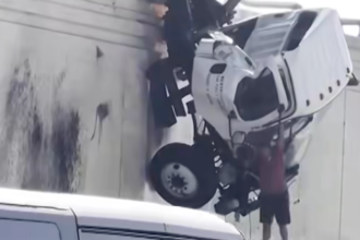 Watch this truck driver jump from a dangling truck cab as good samaritans try to help